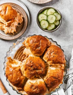 Buffalo chicken sliders are shown on plates with more sliders ready to serve.