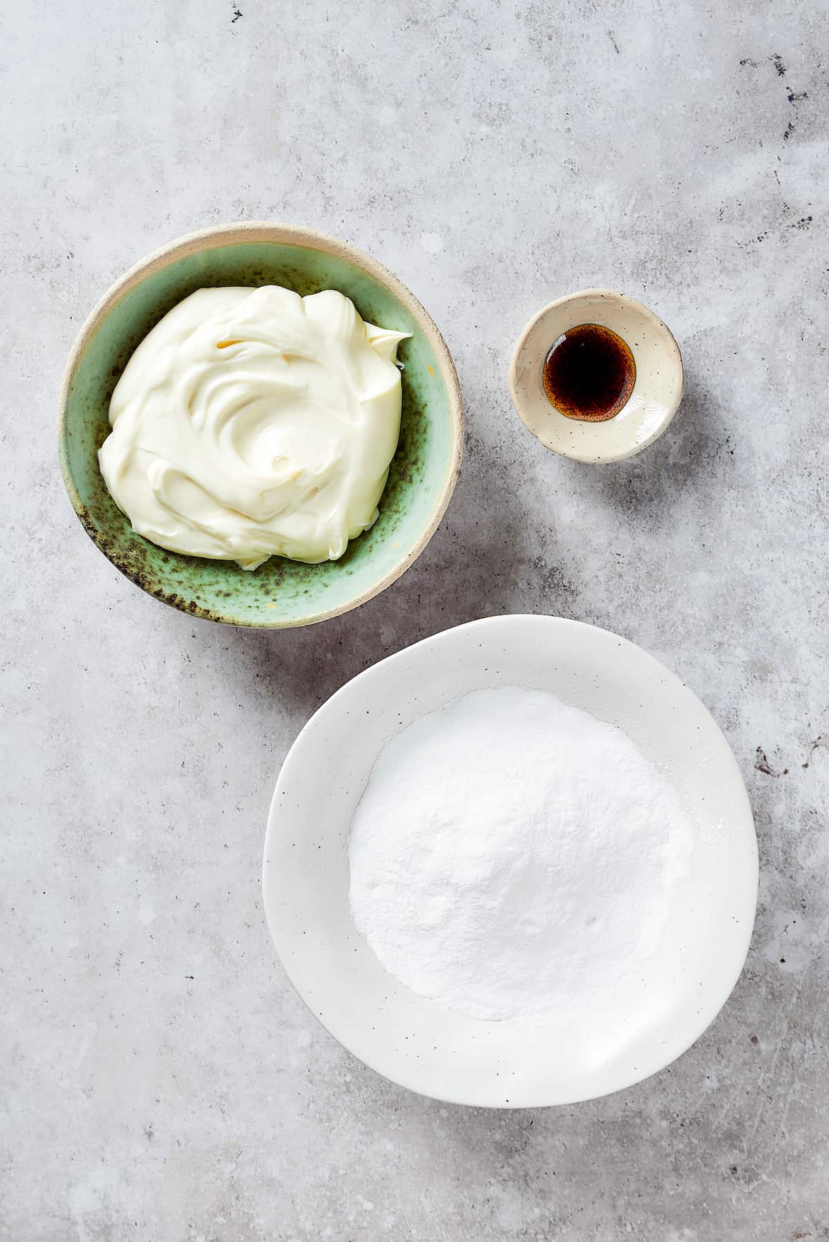 Ingredients for strawberry crunch cake filling are shown including vanilla, cream cheese, and powdered sugar.