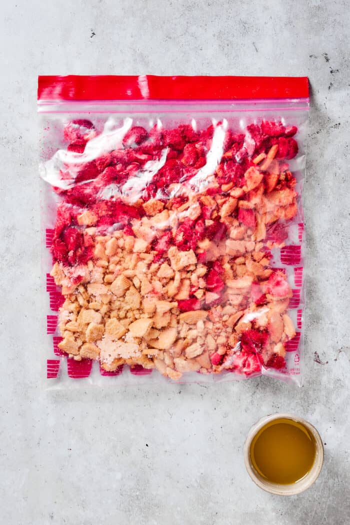 Crushed topping for strawberry crunch cake in a plastic bag.