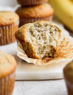 a banana muffin with a couple bites taken out