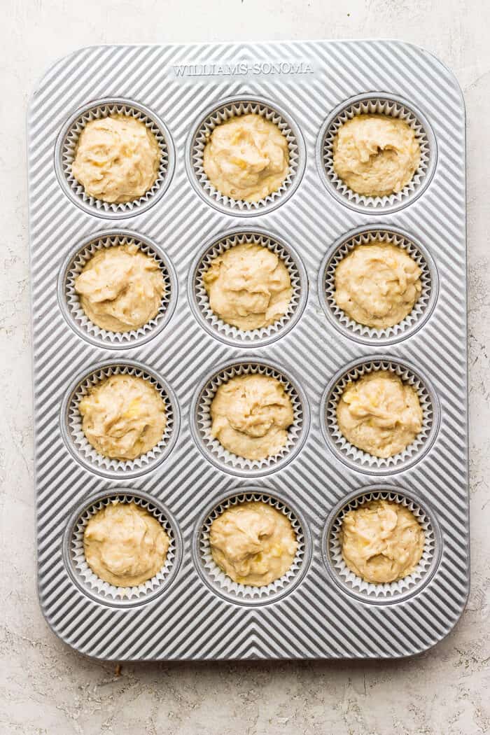 banana muffin batter in muffin pan