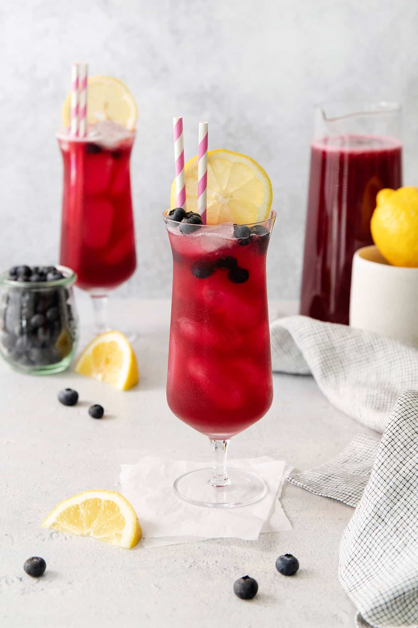 A blueberry lemonade garnished with a lemon slice