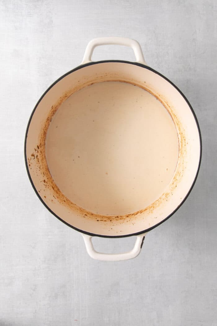 Flour and butter cook into a roux in a pot.