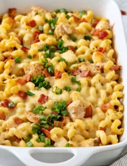A close up shot shows chicken ranch pasta covered with sliced green onions.