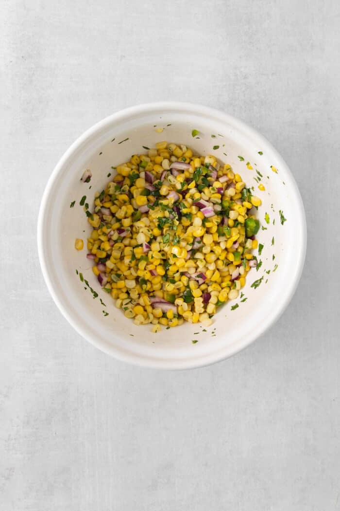 Corn salsa ingredients mixed in a bowl
