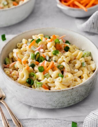 A white bowl of hawaiian macaroni salad on a table.