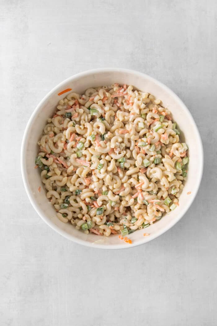 Mixing dressing into a hawaiian macaroni salad.