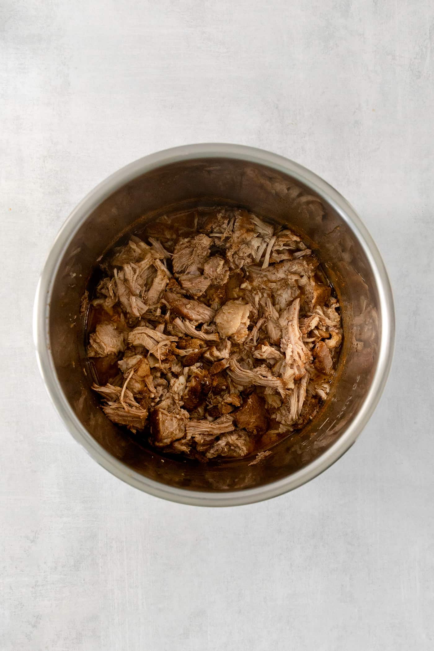 Pork is shown in an Instant Pot.