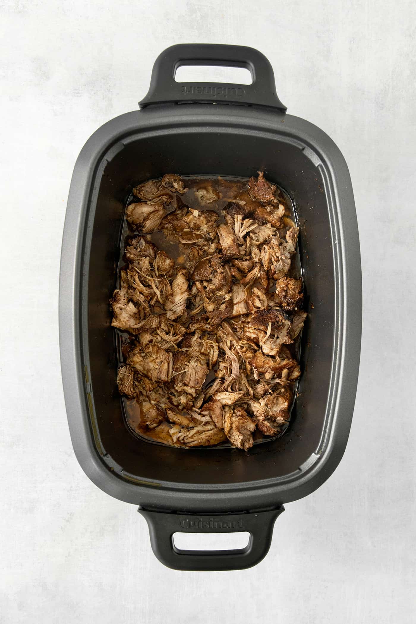 Pork cooks in a slow cooker