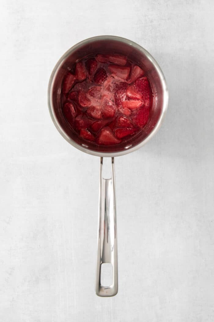 Cooking strawberry puree in a pot.