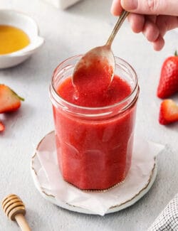 a spoon of strawberry sauce