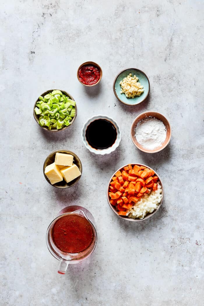 Ingredients needed for rouladen - carrots, celery, onion, garlic, pickles.