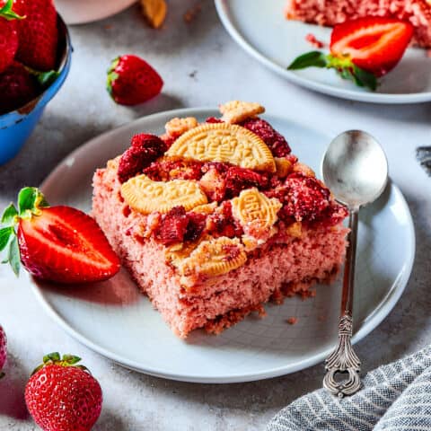 a piece of strawberry cake with a crunchy topping, plus fresh strawberries