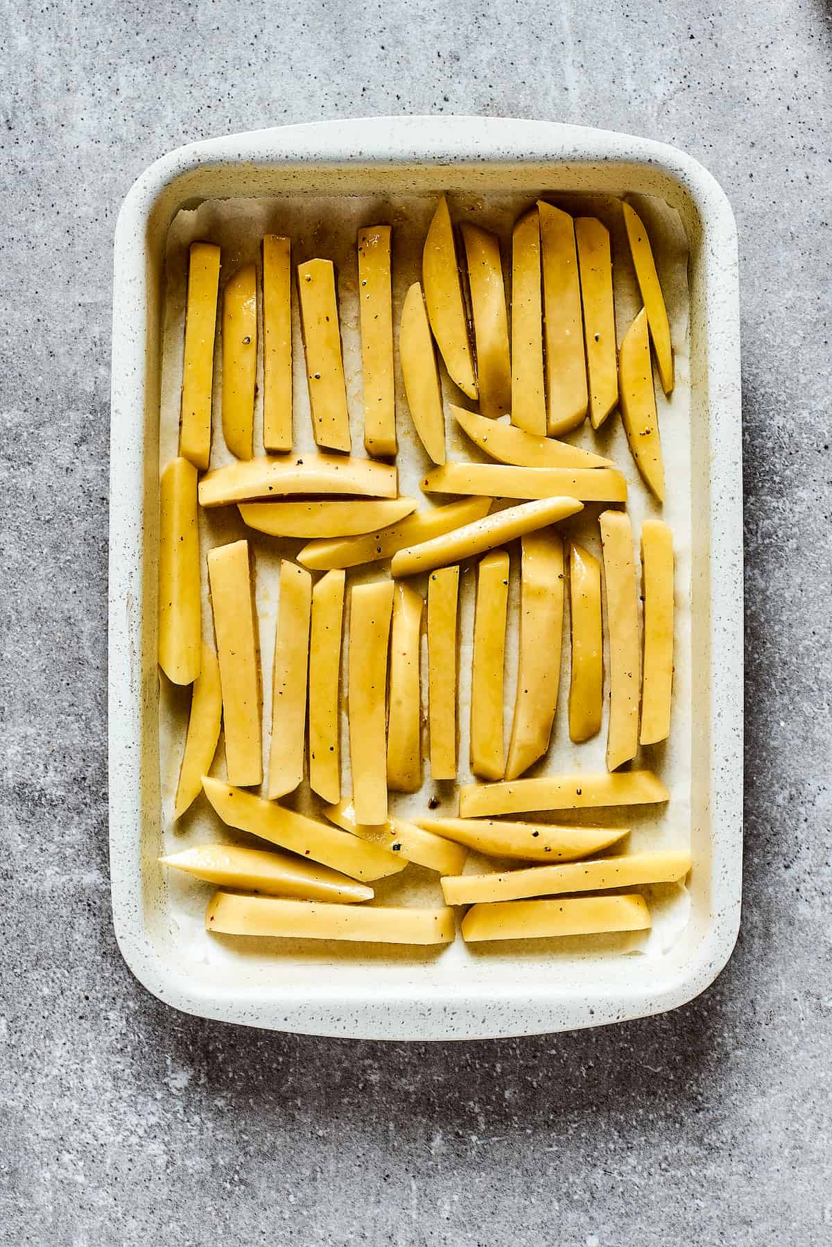 Fries in a white baking dish.