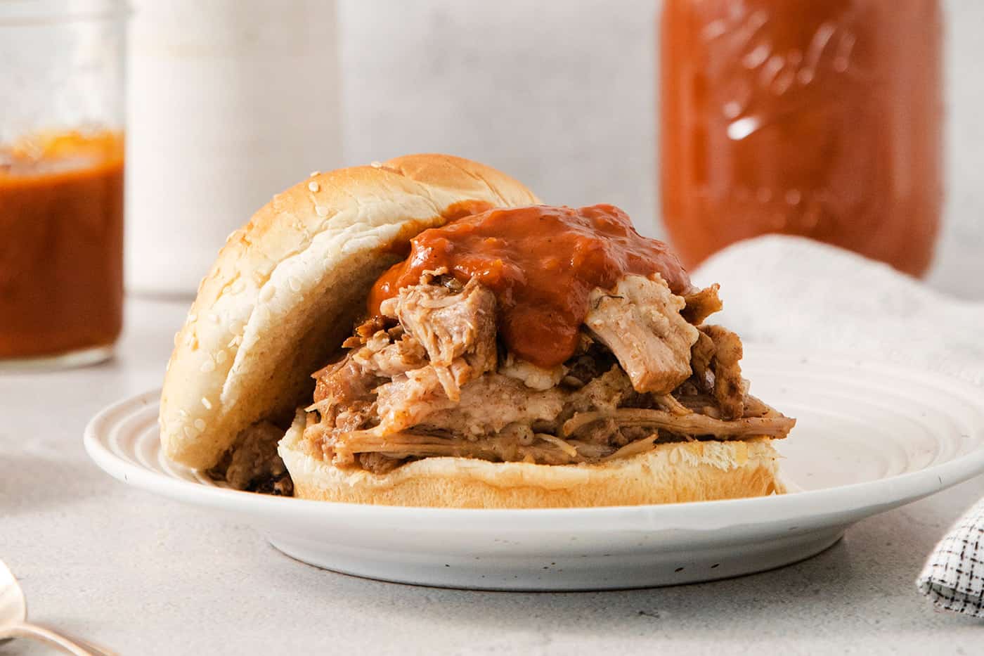 shredded pork on a bun with barbecue sauce