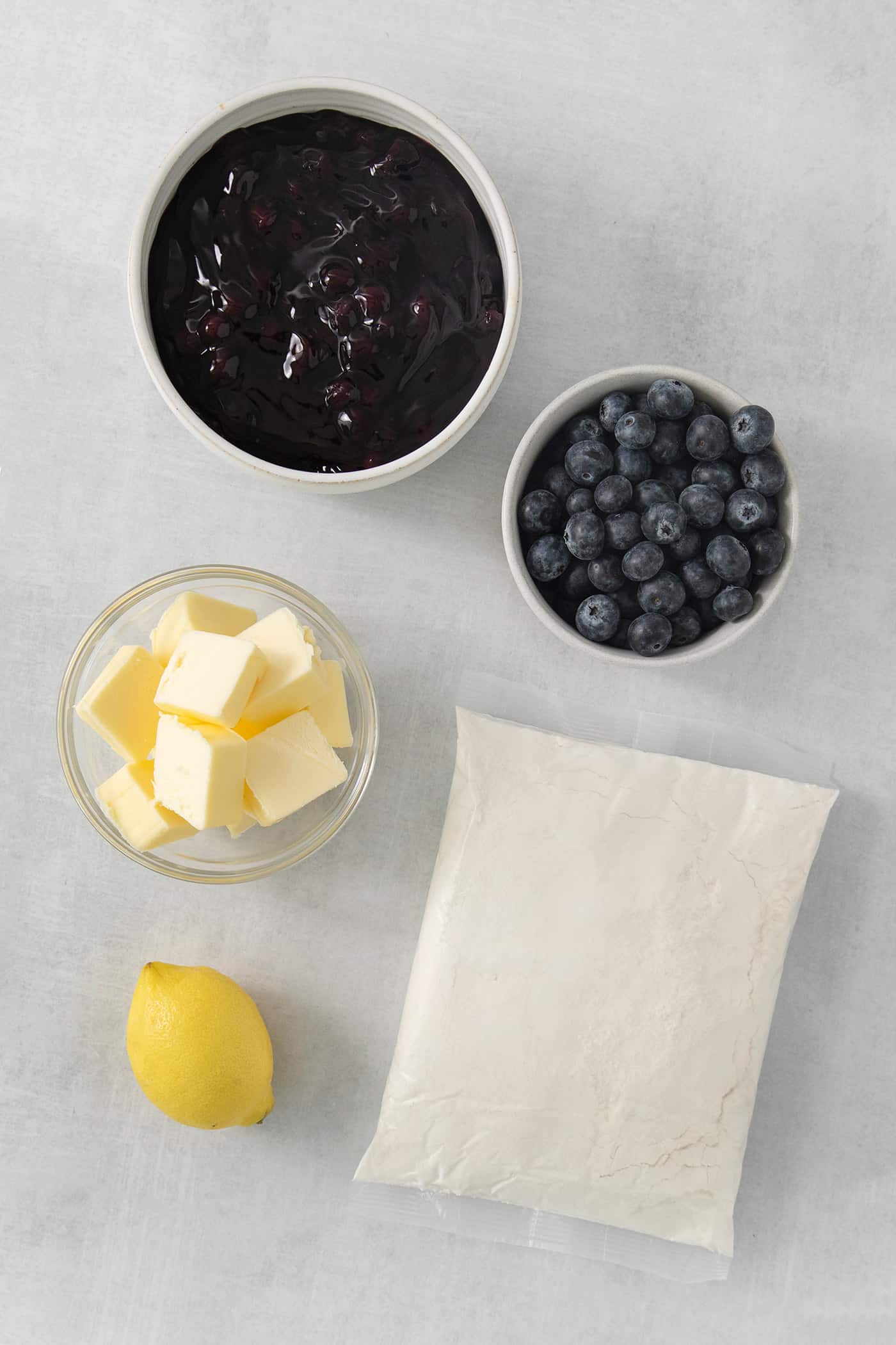 Ingredients for blueberry dump cake: butter, blueberries, pie filling, lemon, and cake mix.