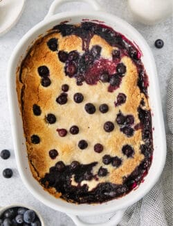 Blueberry dump cake in a white baking dish.