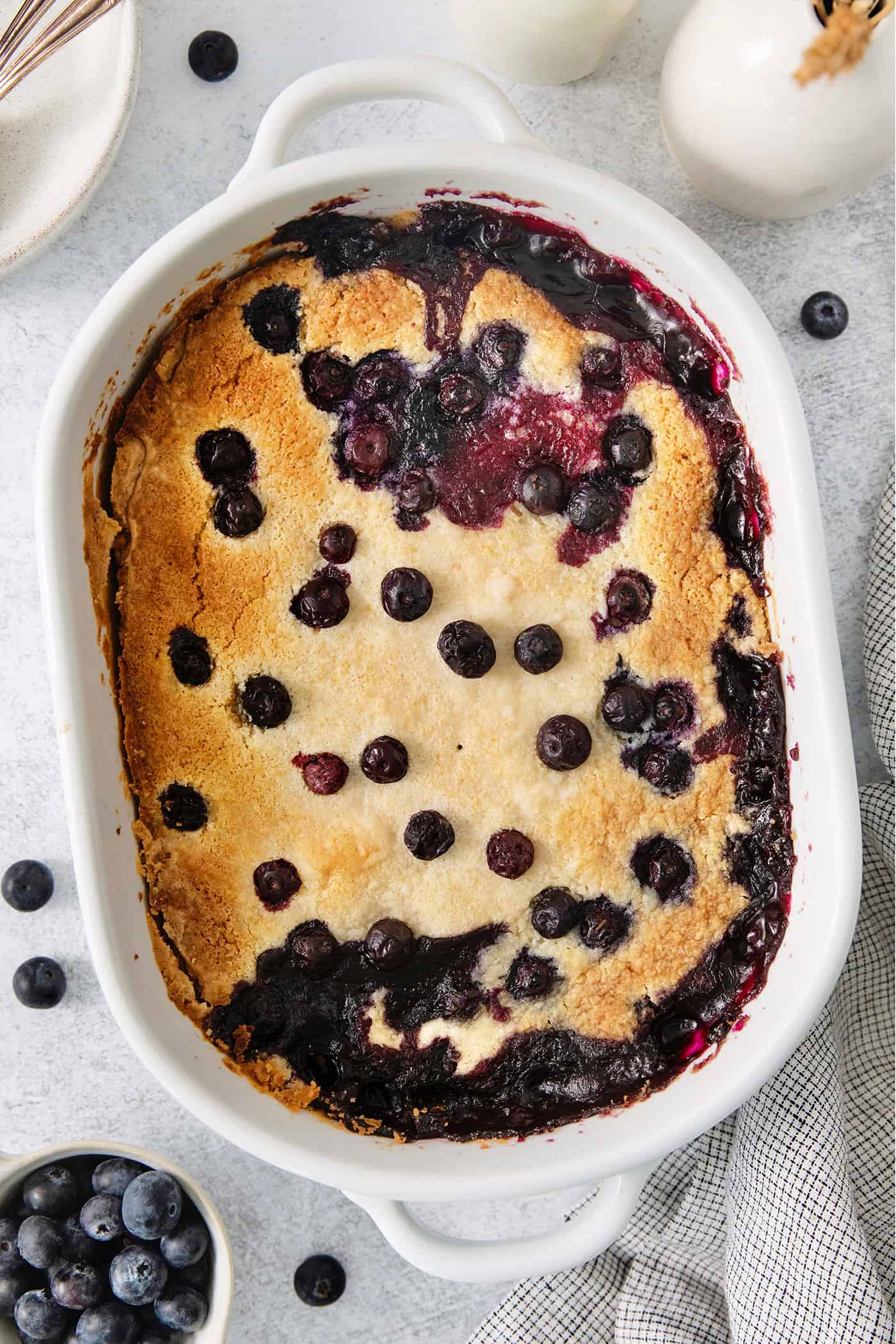 Blueberry dump cake in a white baking dish.