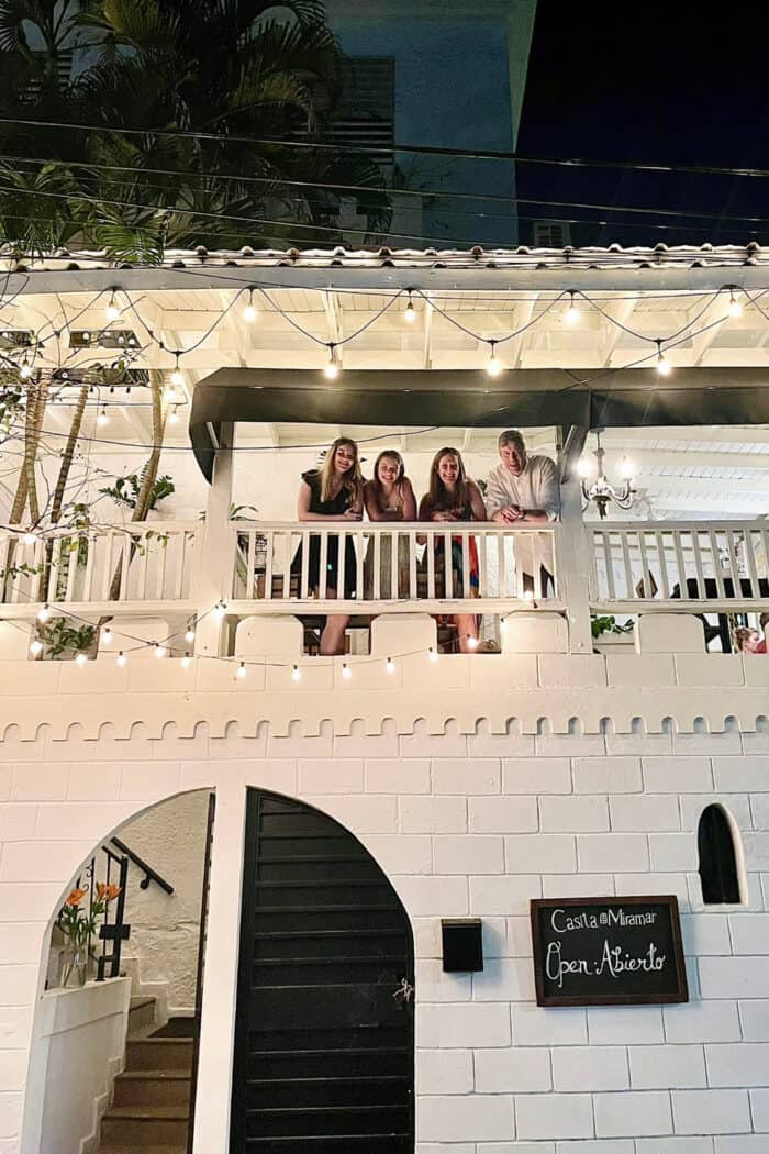 a family of 4 on the balcony at Casita Miramar in San Juan, Puerto Rico
