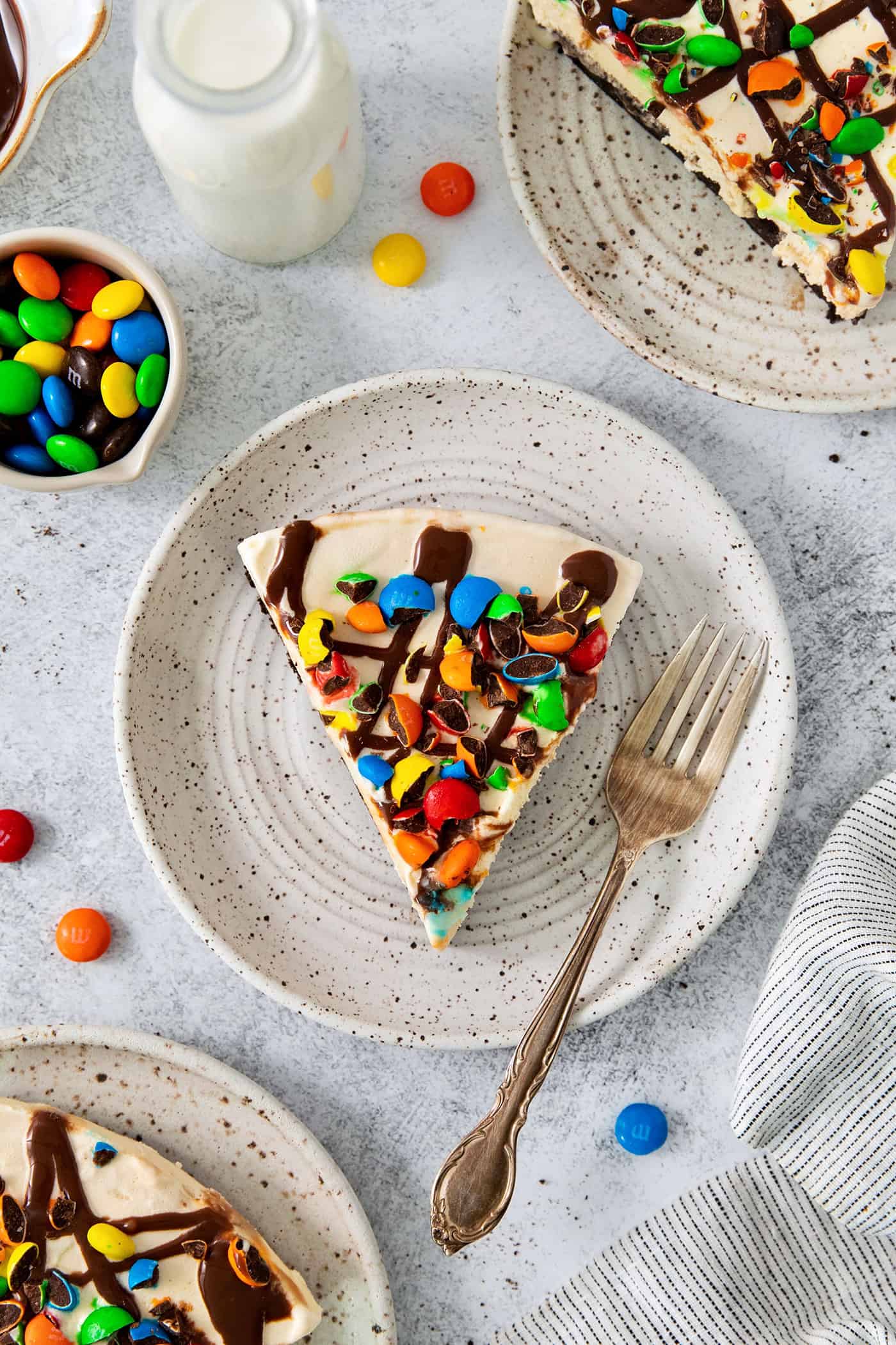 A slice of ice cream pizza on a plate with a fork