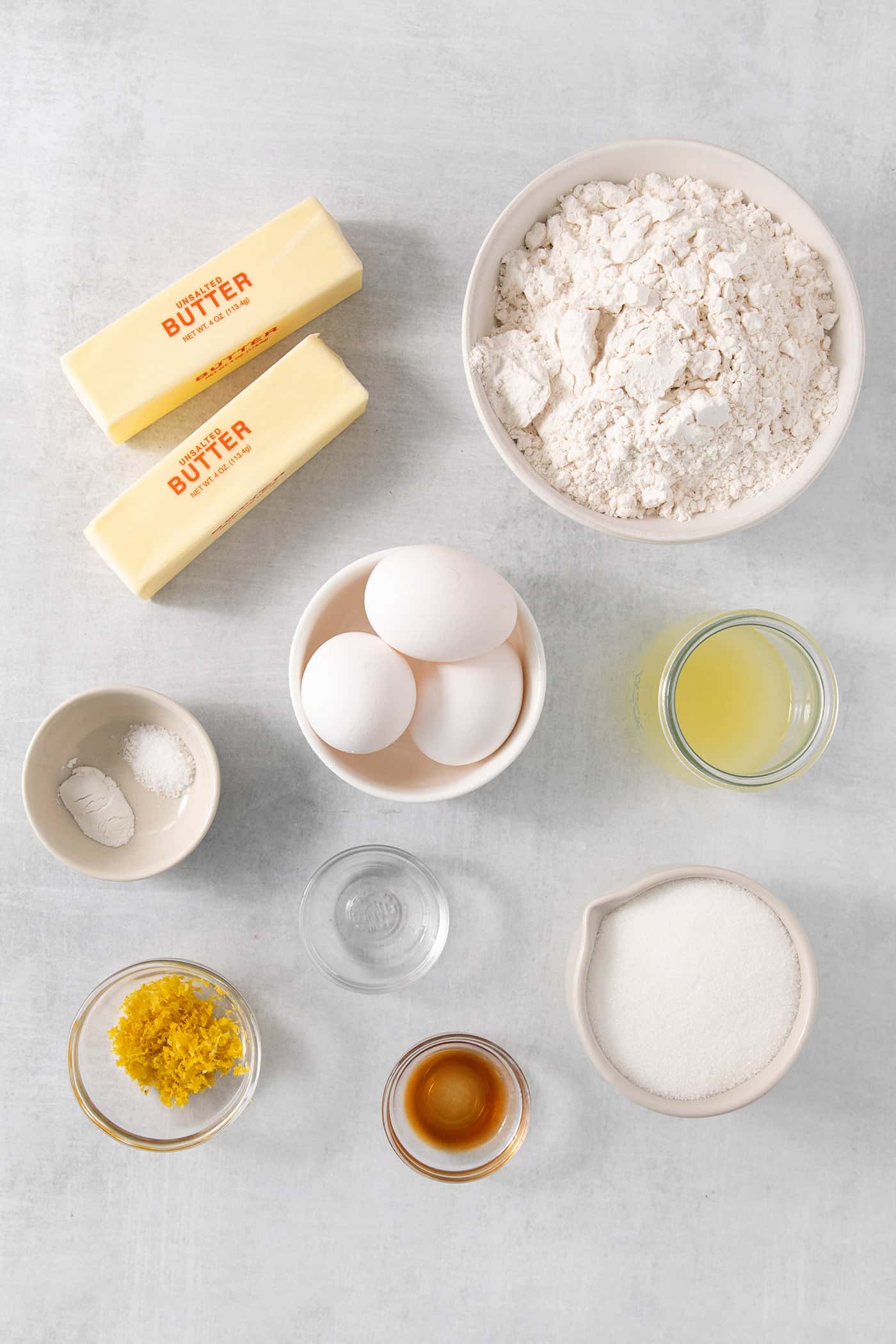 Ingredients for lemon pound cake: butter, sugar, eggs, flour, lemon zest, and vanilla.