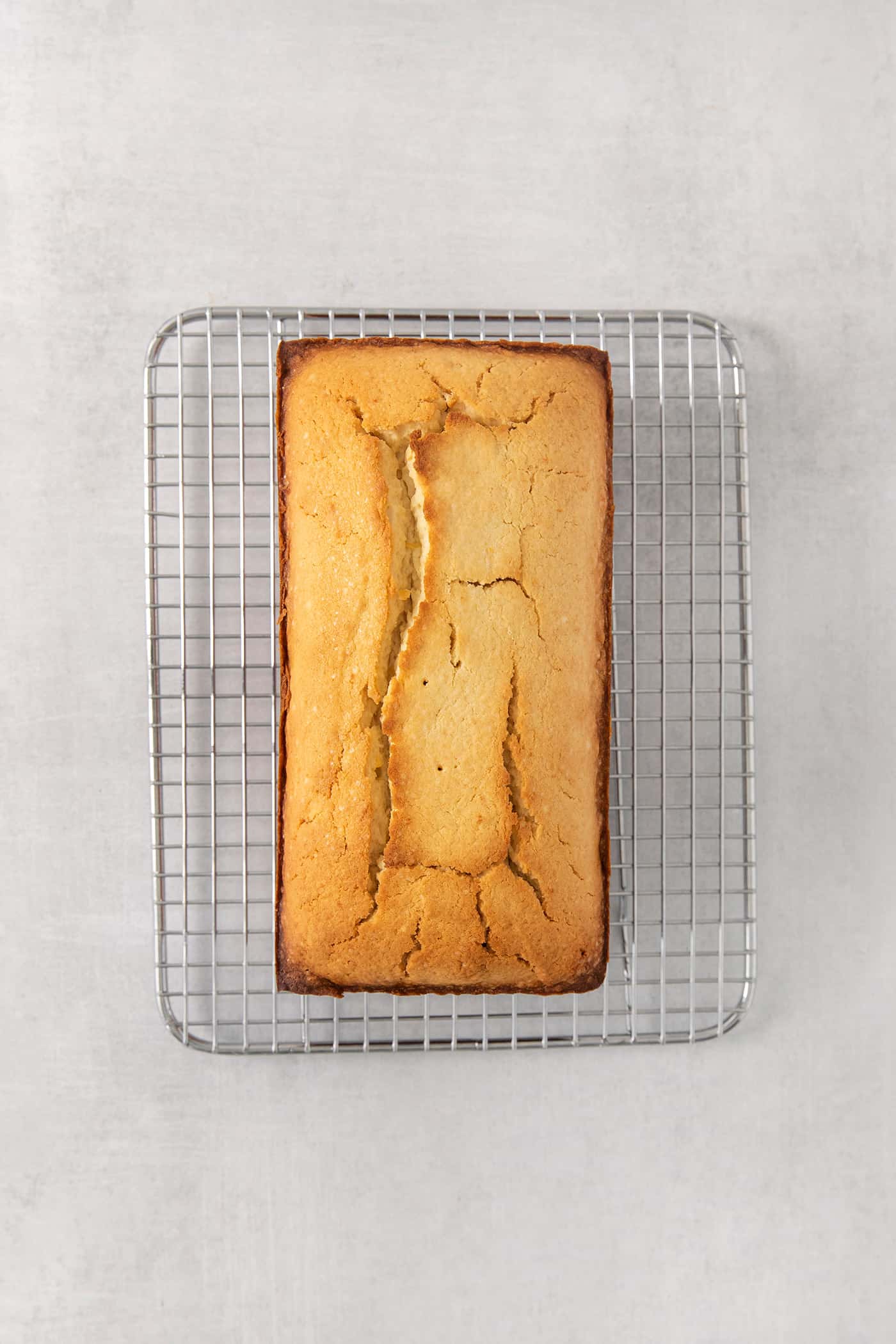 A lemon pound cake on a wire rack.