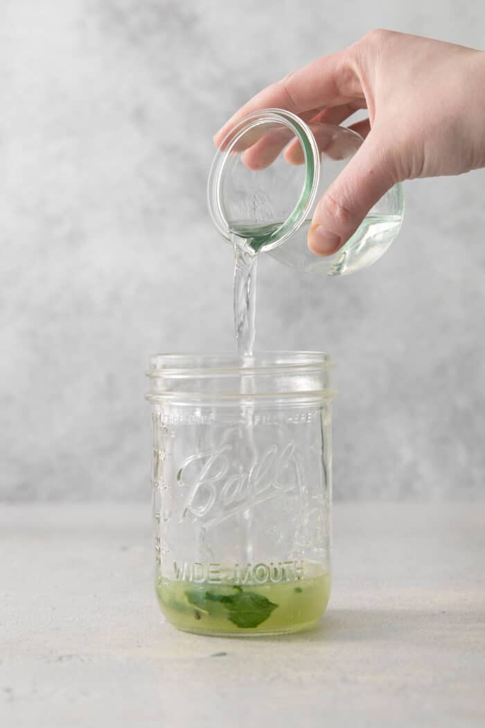 Lime juice is poured into a jar.
