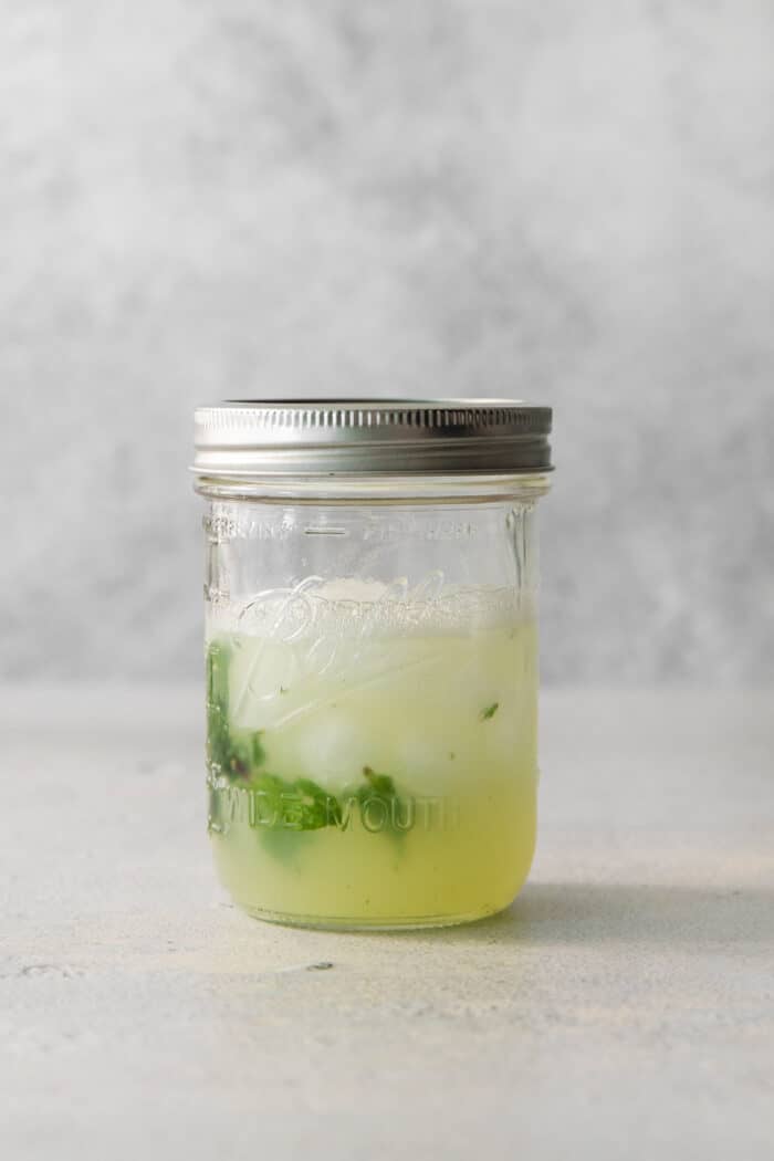 Mojito ingredients are shown in a jar.