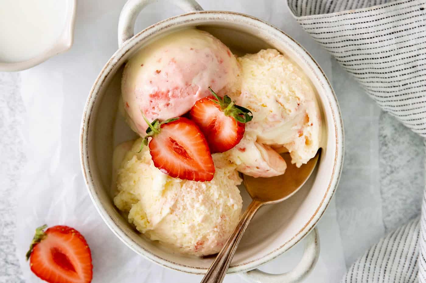 A bowl of crème fraîche strawberry swirl ice cream.