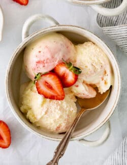 A bowl of crème fraîche strawberry swirl ice cream.