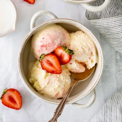 A bowl of crème fraîche strawberry swirl ice cream.