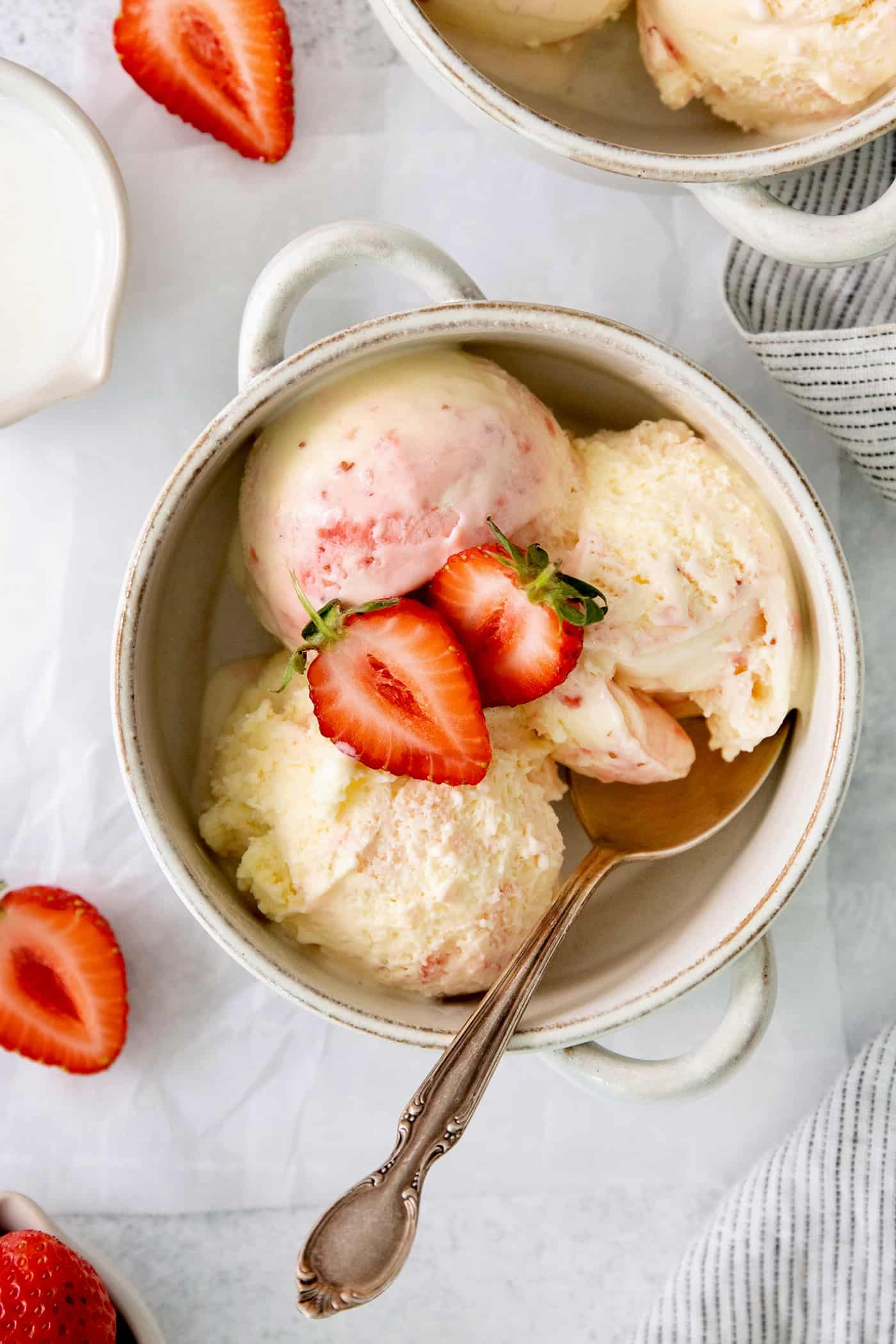 A bowl of crème fraîche strawberry swirl ice cream.