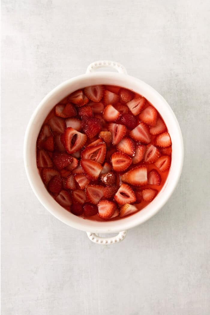 Sliced strawberries in a bowl.