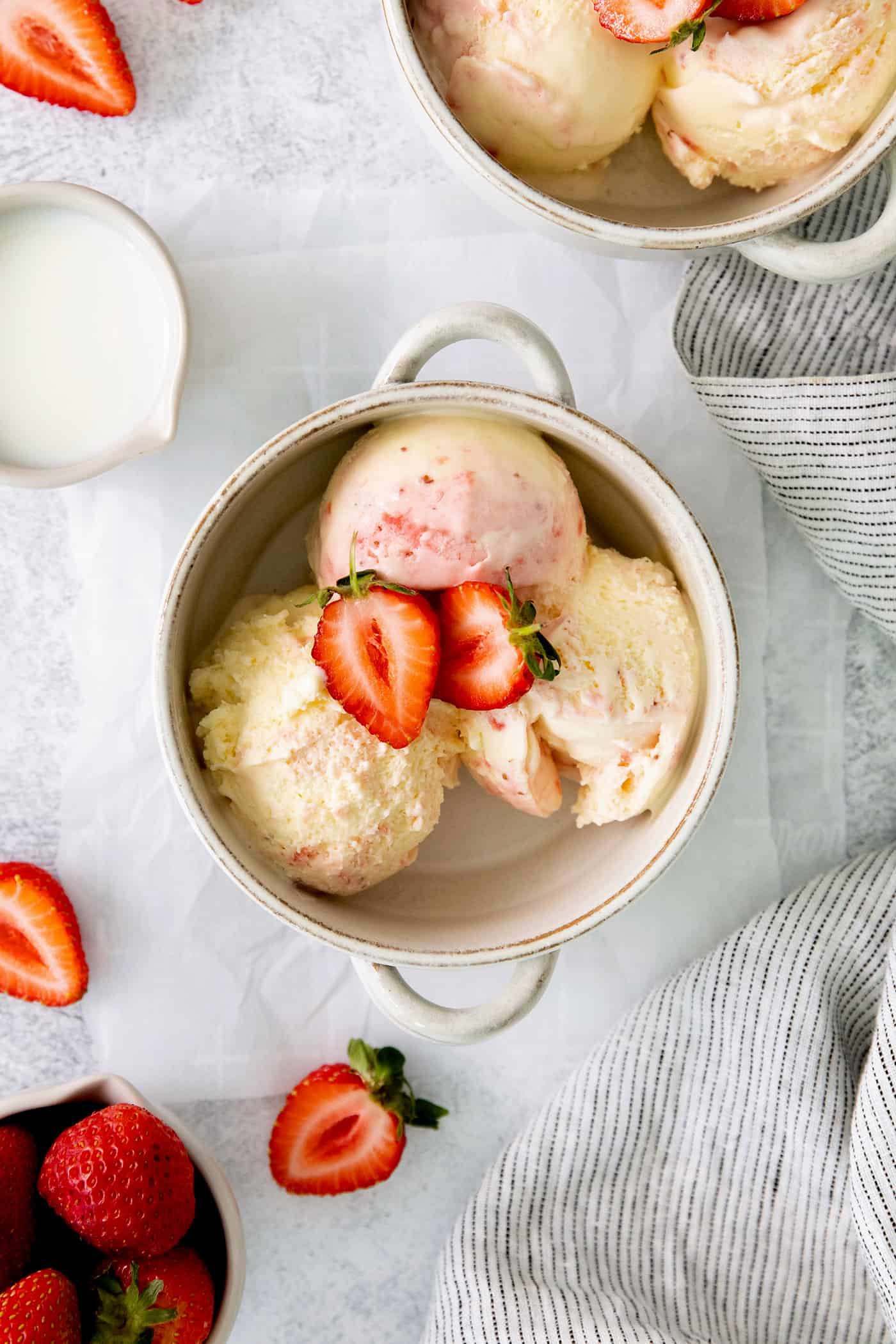 A bowl of crème fraîche strawberry swirl ice cream.