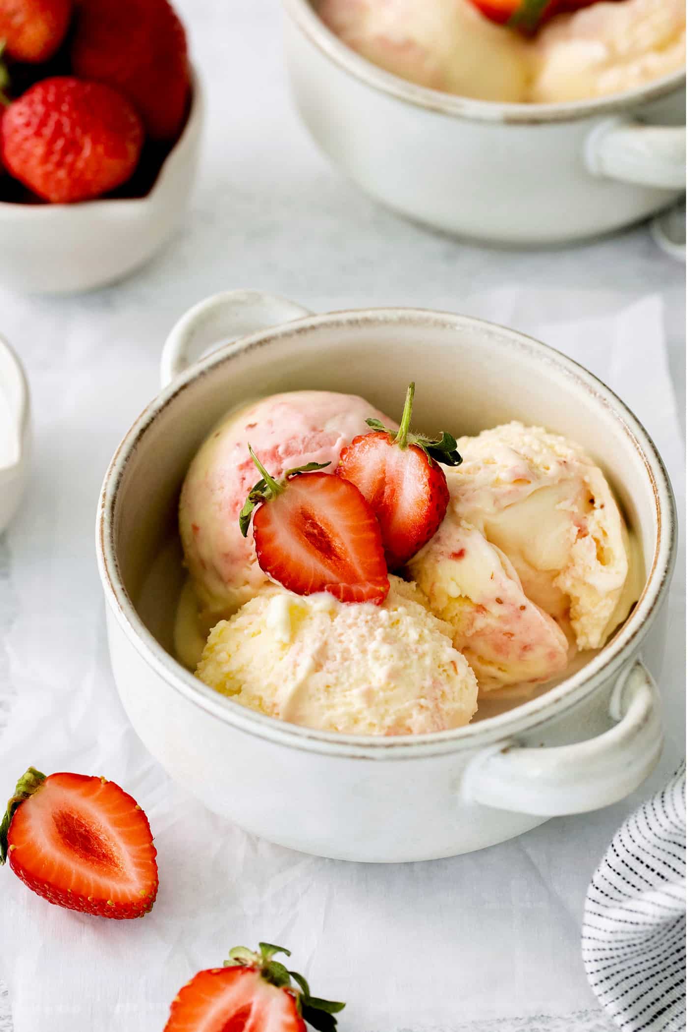 A bowl of crème fraîche strawberry swirl ice cream.