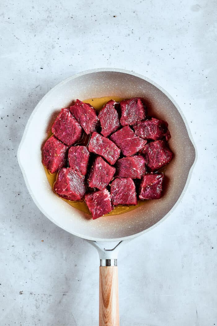 Cooking the steak bites in a skillet.