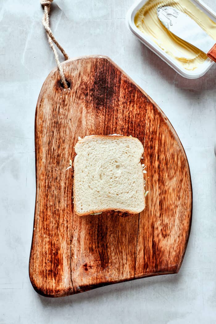 A piece of bread on a cutting board.