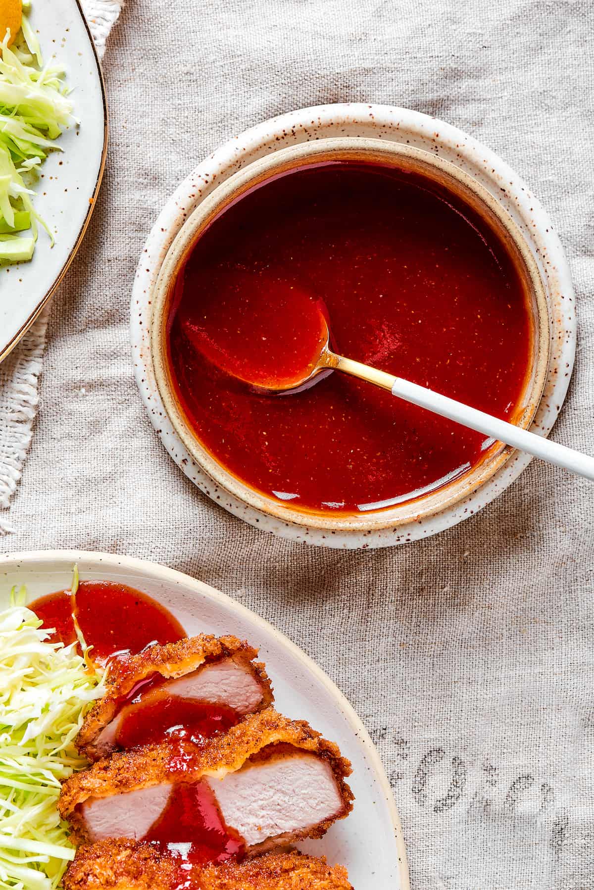 A bowl of tonkatsu sauce with a spoon.
