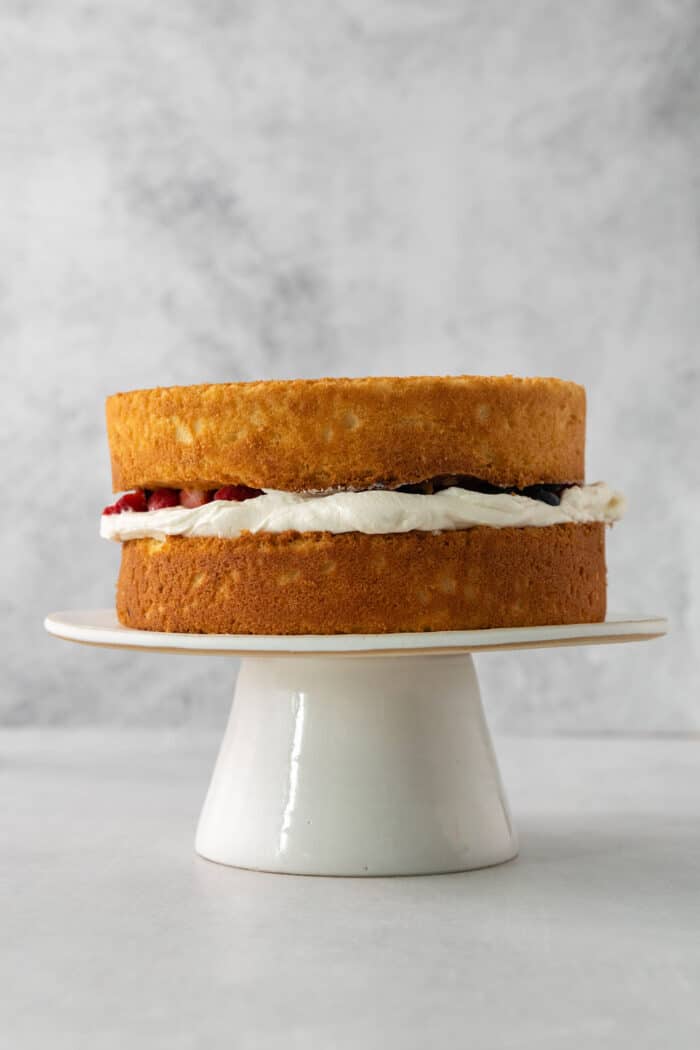 Cake layers with cream filling and berries.