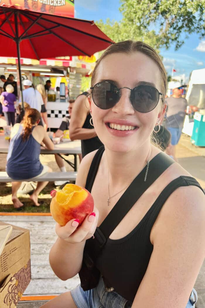 a girl eating a peach