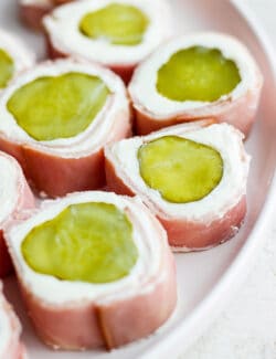 Pickle roll up are shown on a plate.