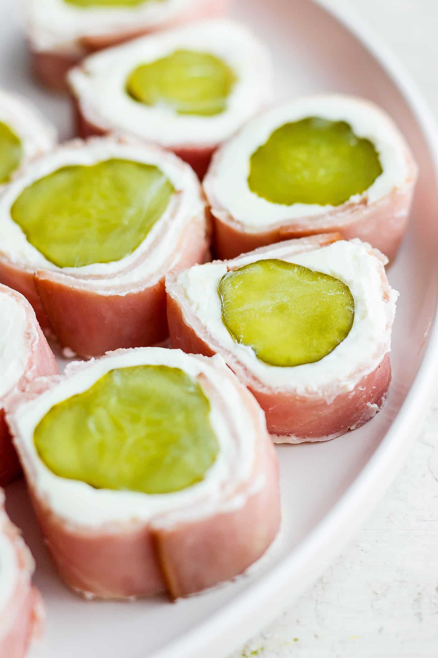 Pickle roll up are shown on a plate.