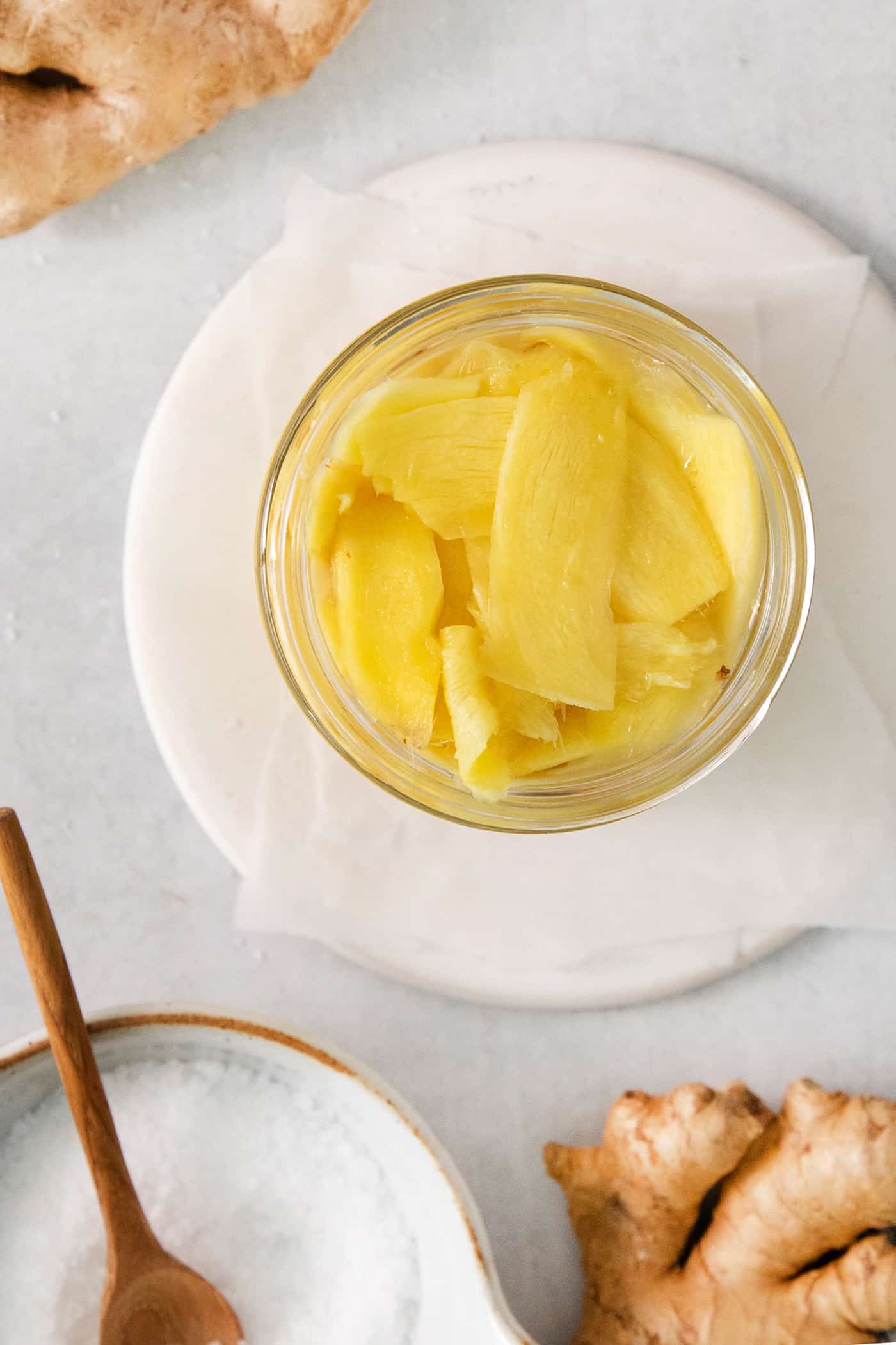 Pickled ginger is shown in a jar.