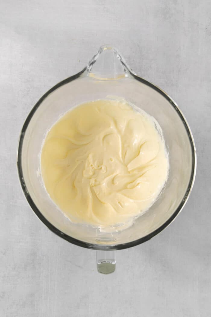 Cream cheese in a clear bowl.