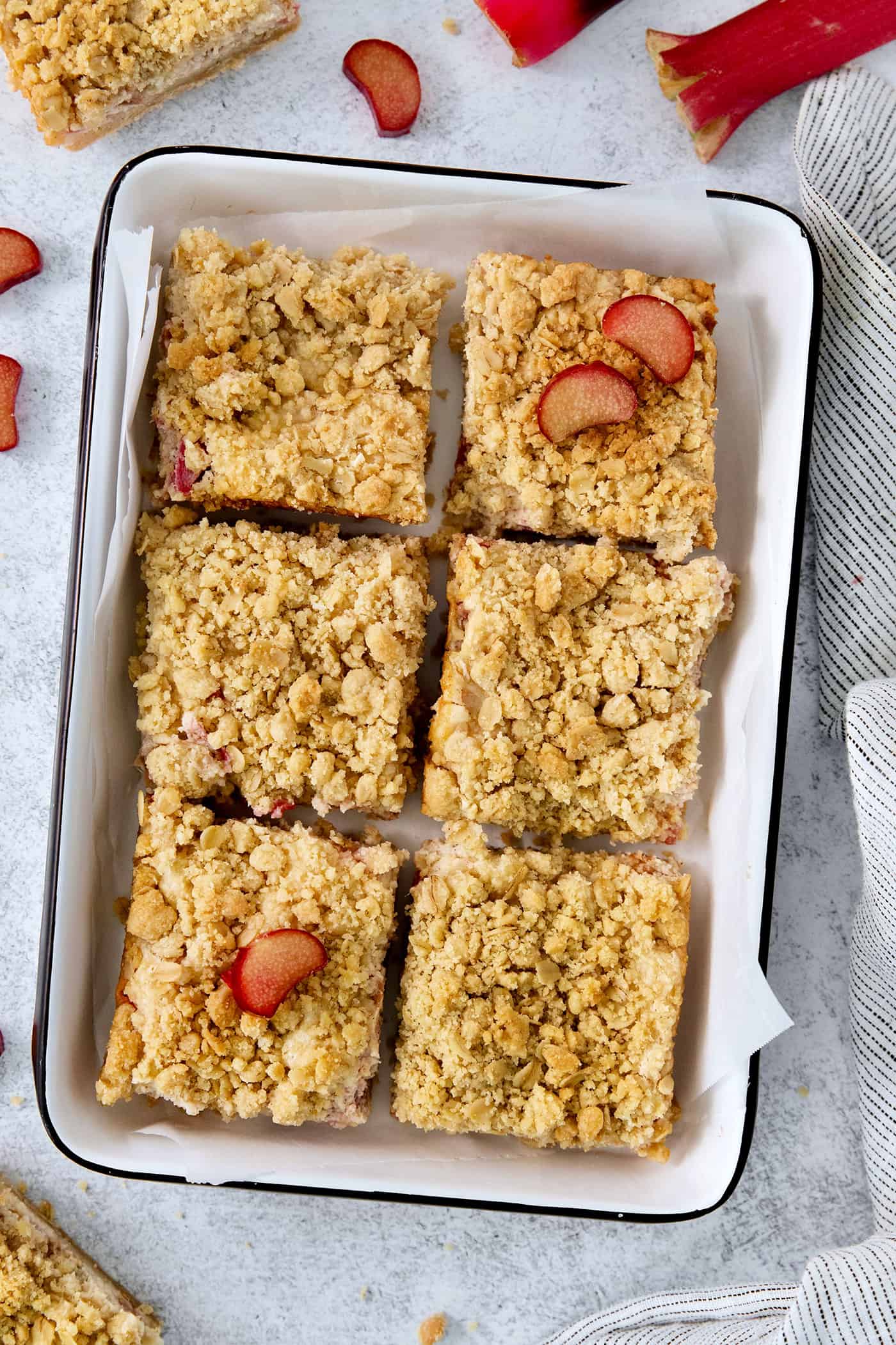 Six rhubarb bars are shown on a tray.