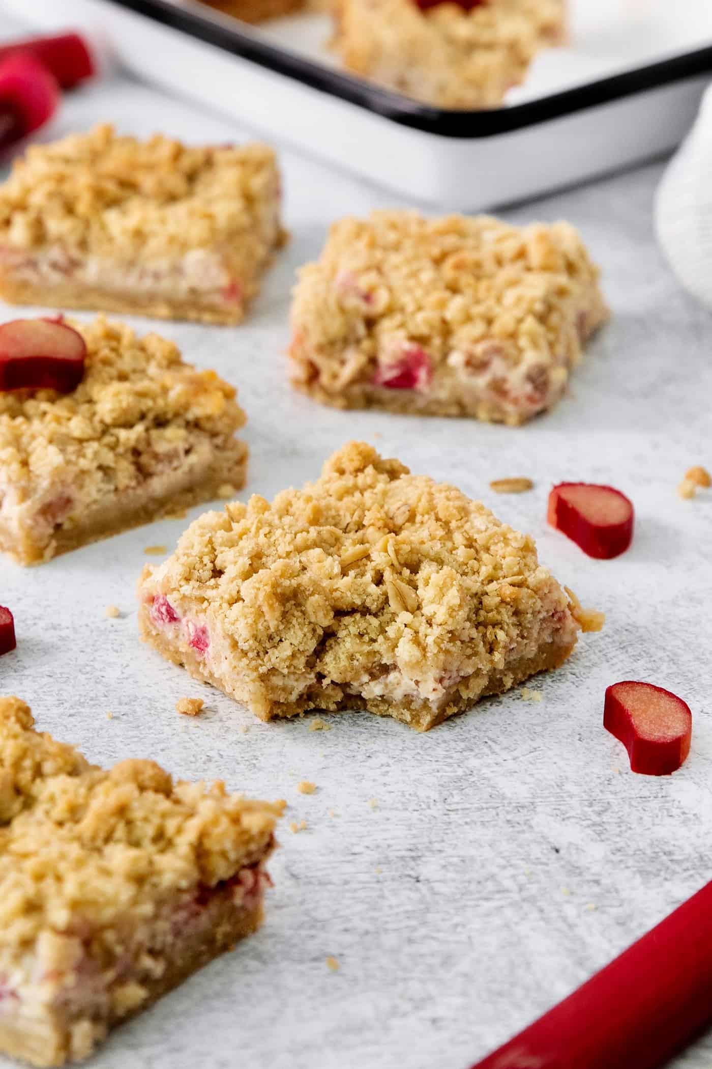 Rhubarb cream cheese bars on a white background.