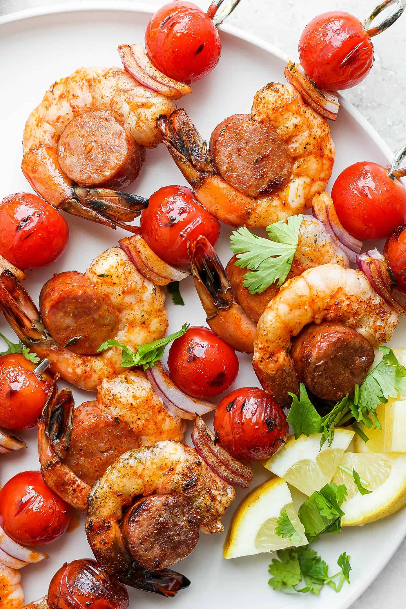A close up of shrimp and sausage kabobs.