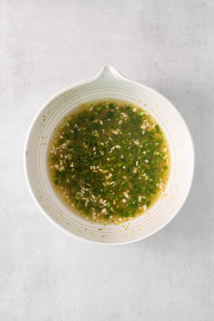 The green dressing for tropical shrimp salad is shown in a white bowl.