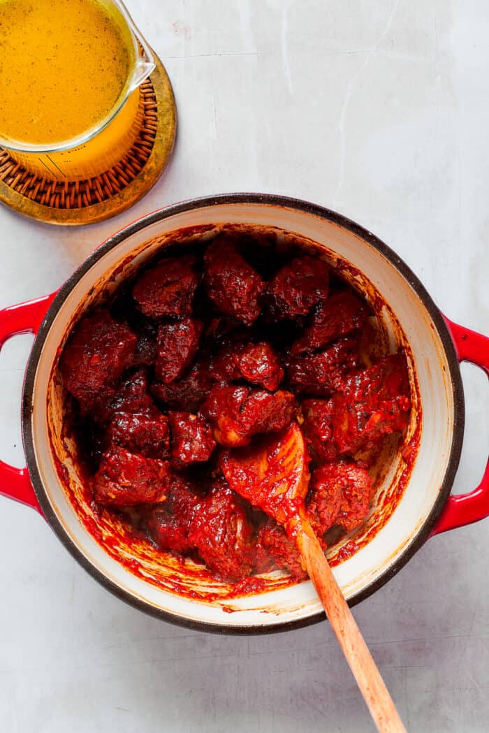 Tomato paste is stirred into a pot of Mulligan stew.