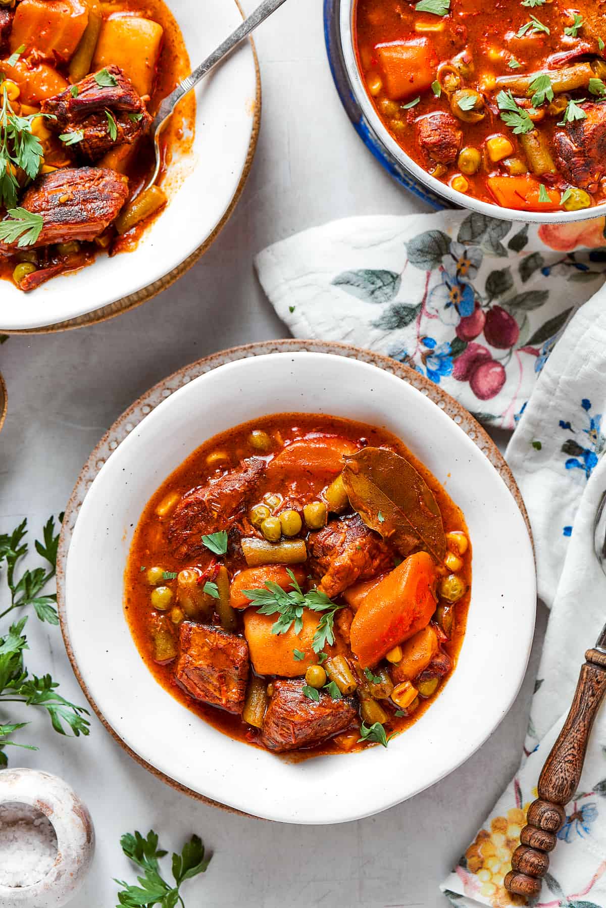 Bowls of Mulligan stew are shown on a flowered tablecloth.